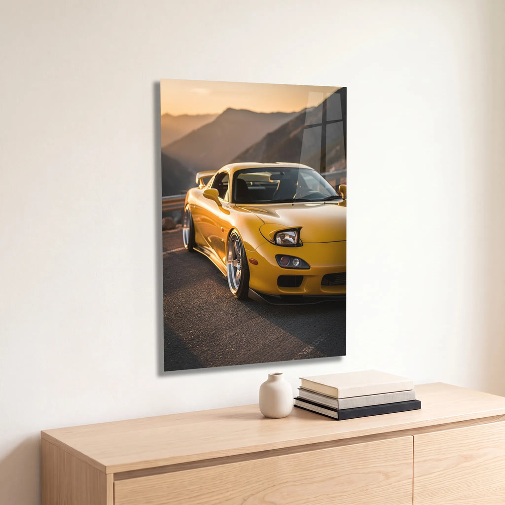 Poster métal Mazda RX-7 FD jaune sur une route de montagne accroché au-dessus d'un canapé dans un salon